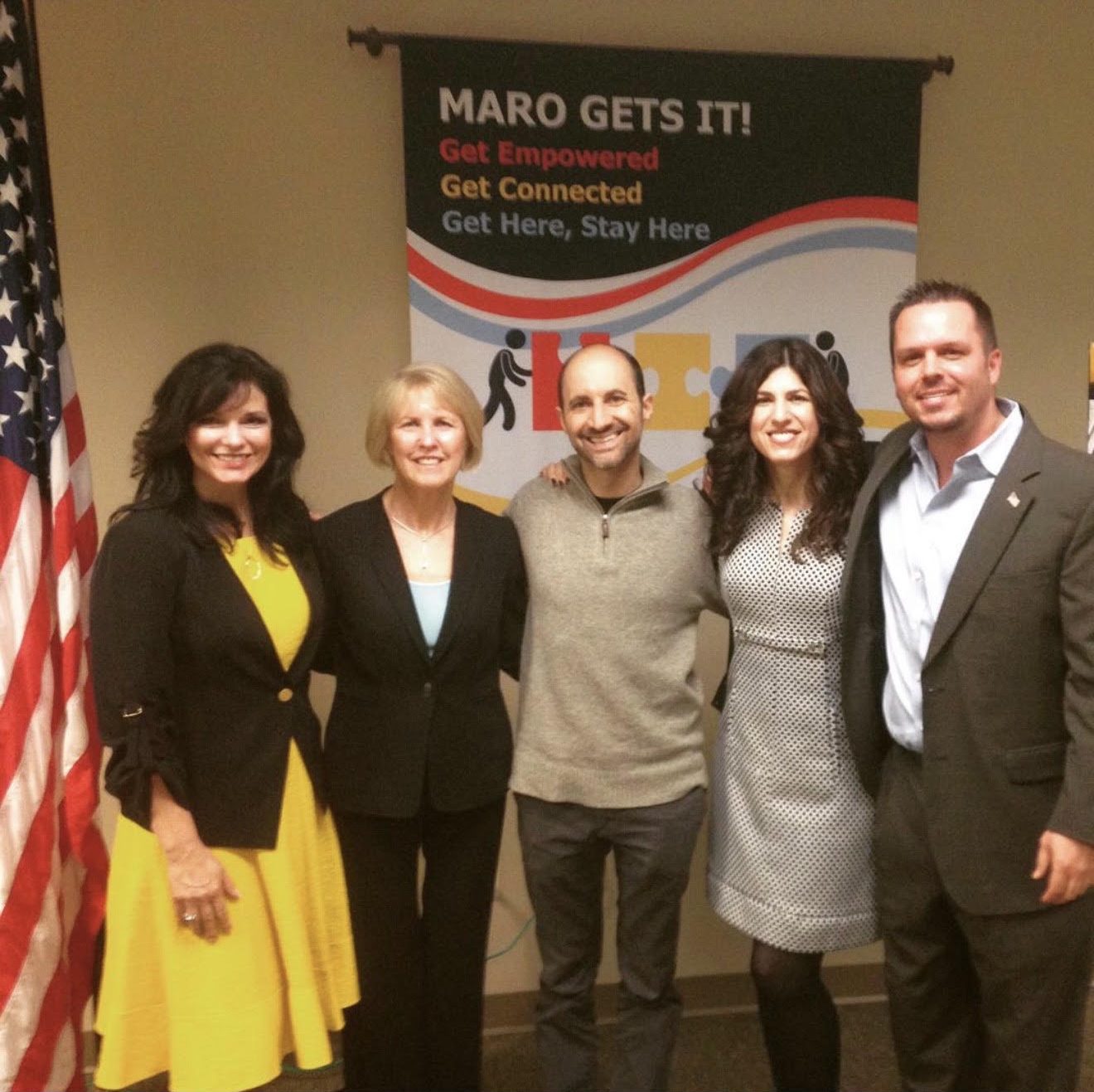 Jody Fuller with four members of the USDA Food and Nutrition Service Mid-Atlantic Regional Office program in front of a MARO Gets It banner and an American flag in Robbinsville, New Jersey